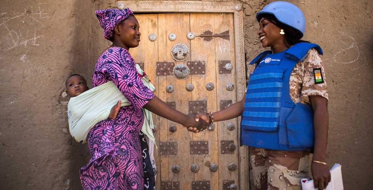 An UNPOL officer greets a woman and her baby while on patrol in Timbuktu